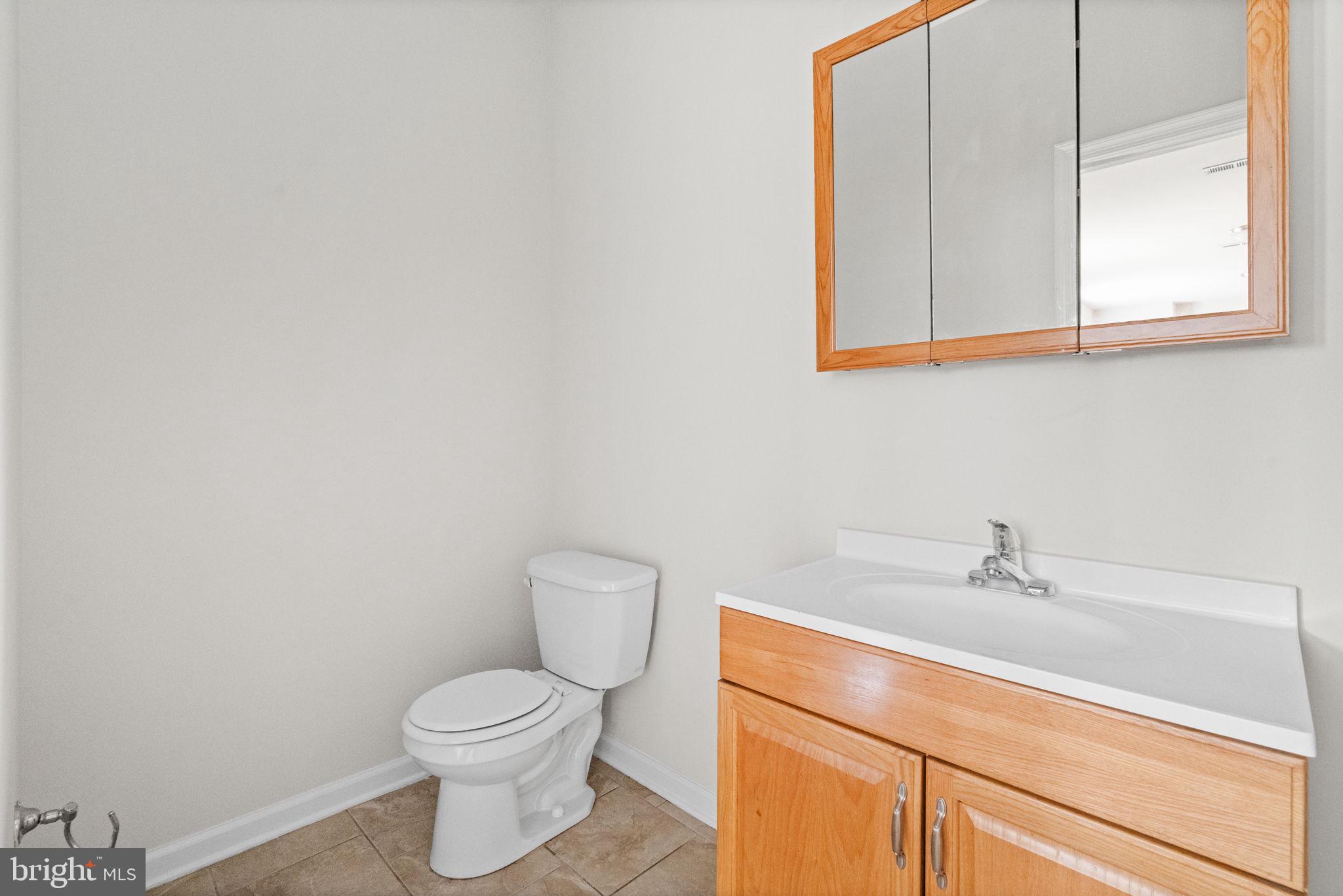 2106 North 17th Street Philadelphia, PA 19121 - Photo 44 of 84 a bathroom with a sink a toilet and a mirror