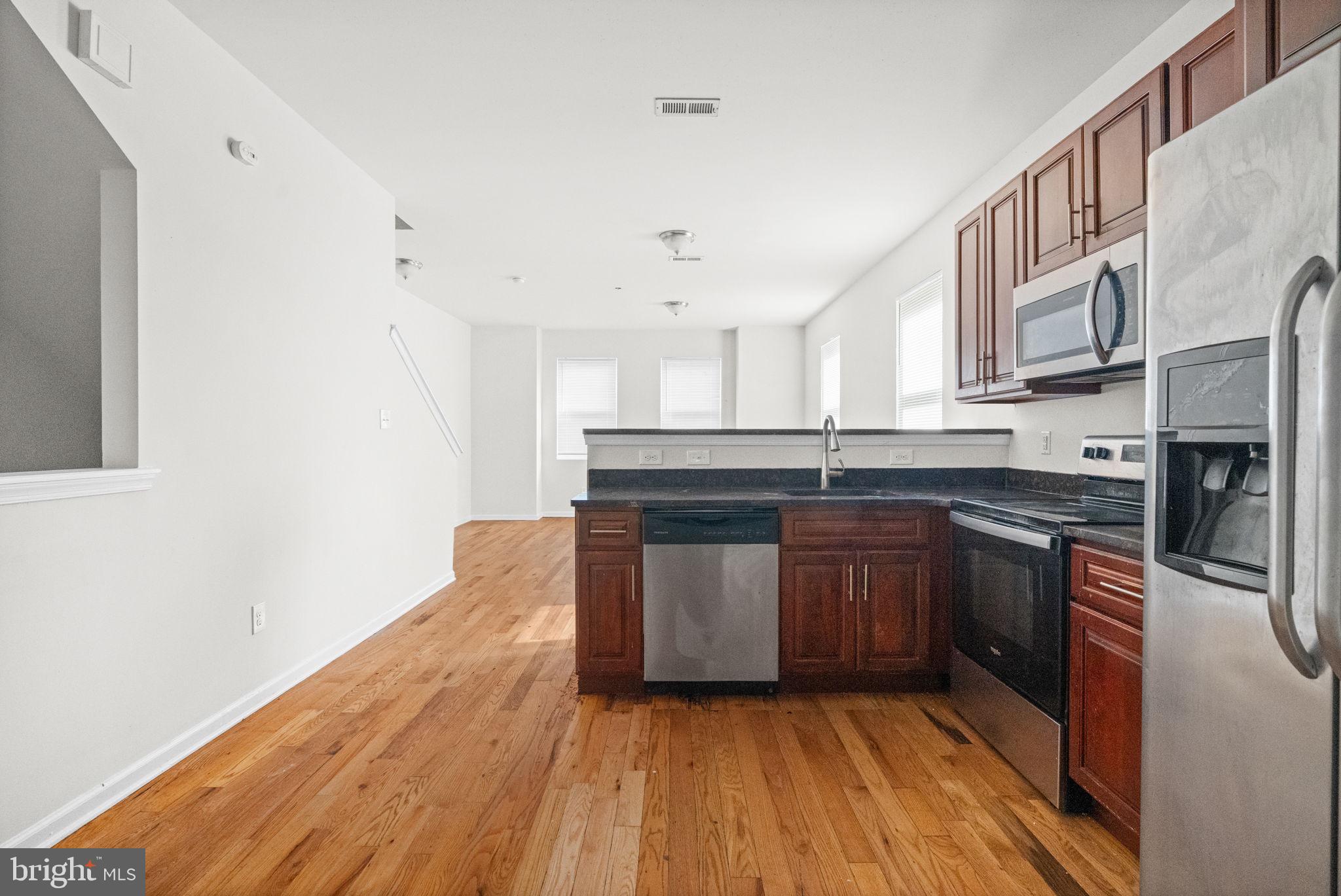 2106 North 17th Street Philadelphia, PA 19121 - Photo 46 of 84 a kitchen with stainless steel appliances granite countertop a stove a sink and a refrigerator