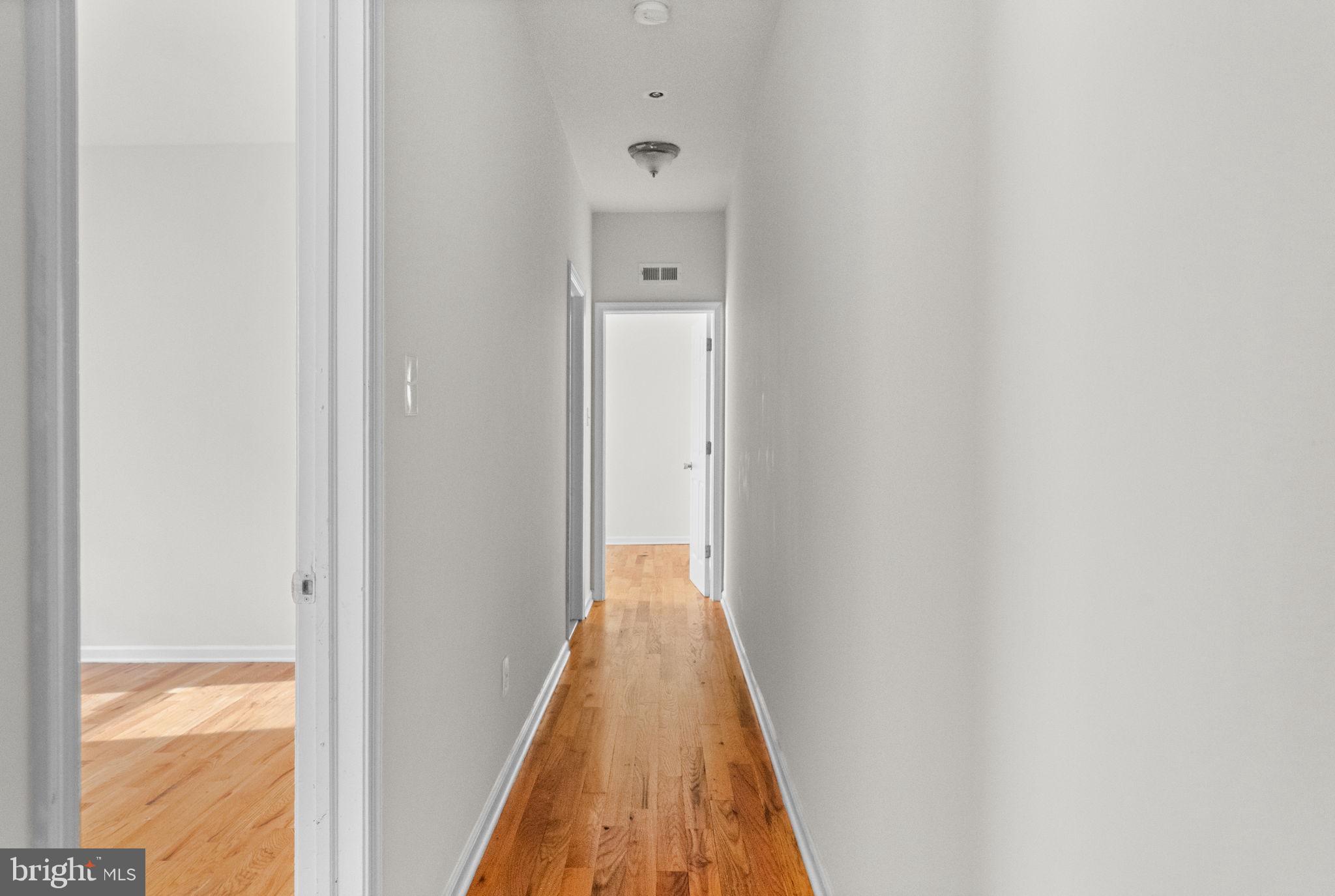 2106 North 17th Street Philadelphia, PA 19121 - Photo 55 of 84 a view of a hallway with wooden floor and a bathroom