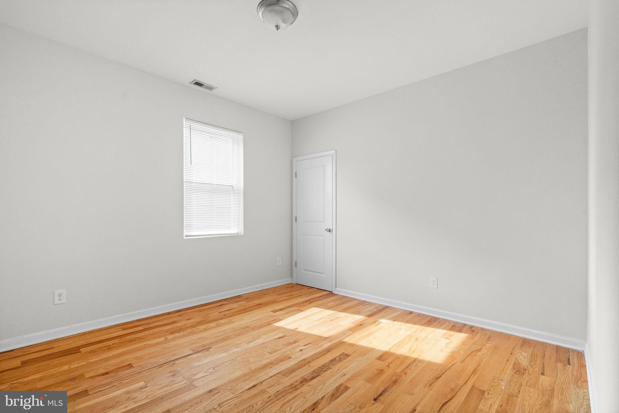 2106 North 17th Street Philadelphia, PA 19121 - Photo 56 of 84 an empty room with wooden floor and windows