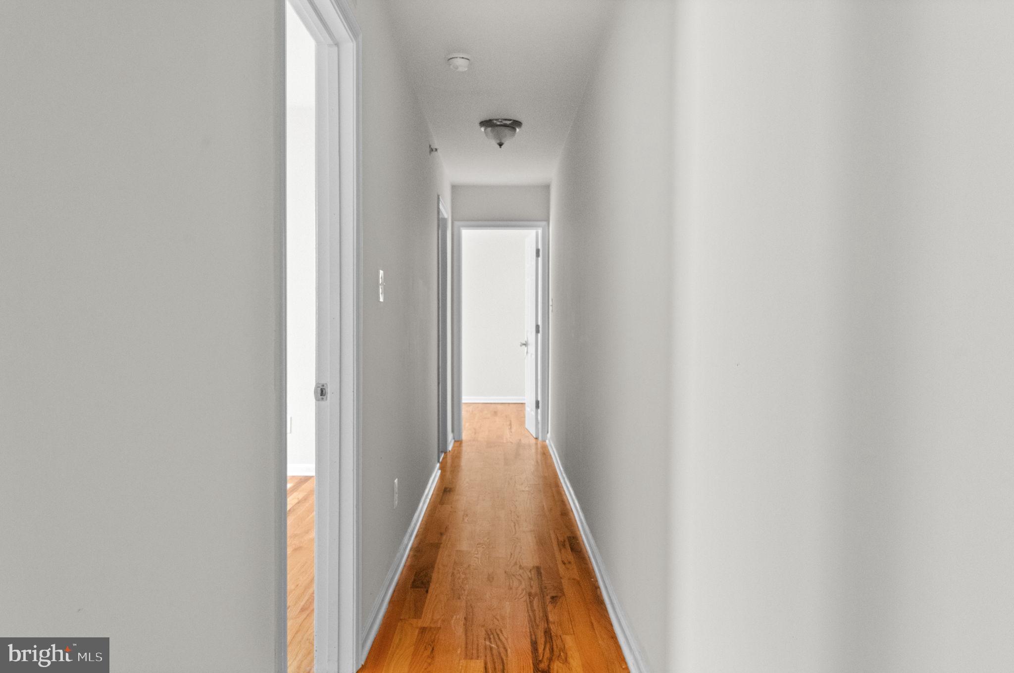 2106 North 17th Street Philadelphia, PA 19121 - Photo 65 of 84 a view of a hallway with wooden floor and a bathroom