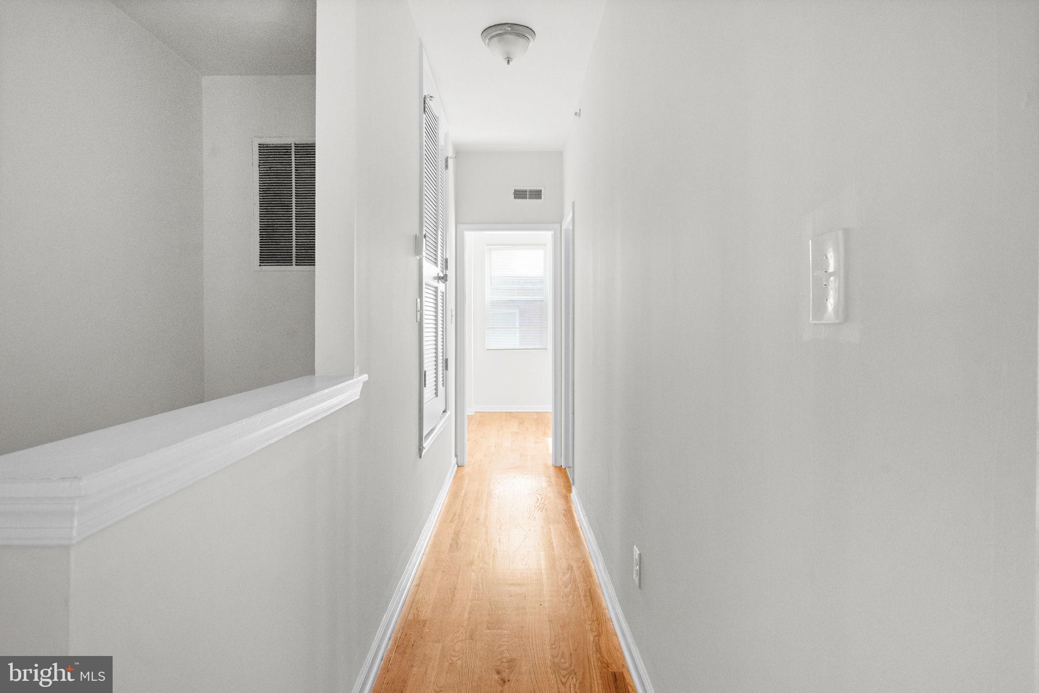 2106 North 17th Street Philadelphia, PA 19121 - Photo 75 of 84 a view of a hallway with wooden floor
