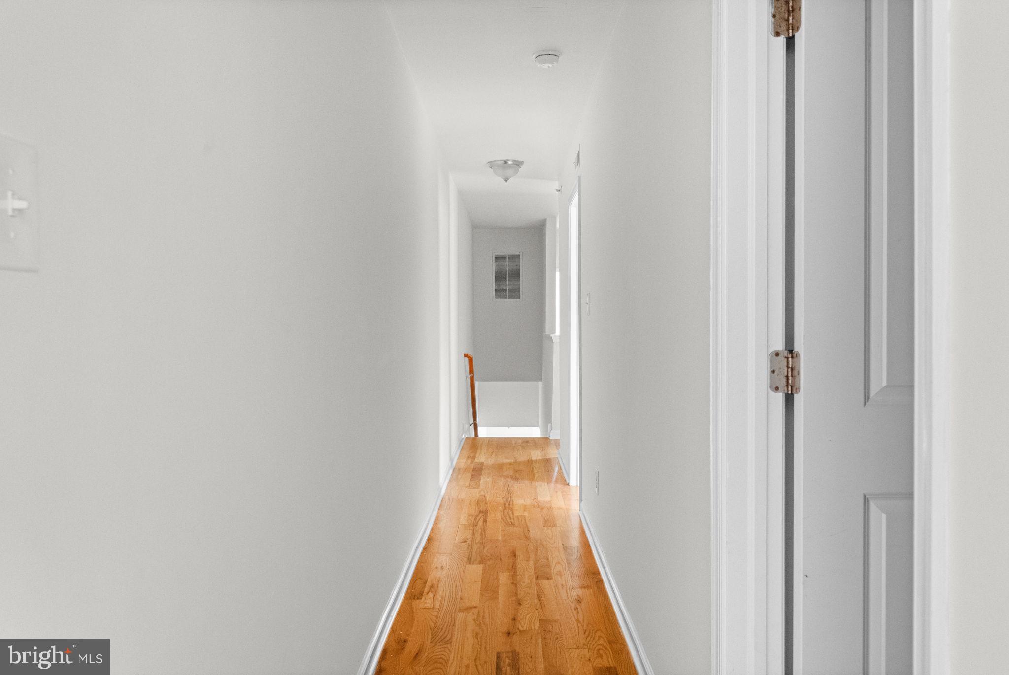 2106 North 17th Street Philadelphia, PA 19121 - Photo 79 of 84 a view of a hallway with wooden floor and a bathroom