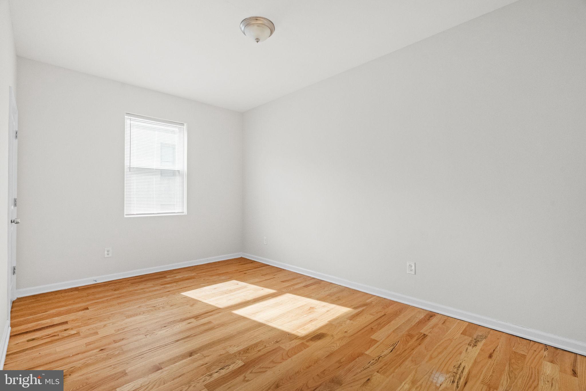 2106 North 17th Street Philadelphia, PA 19121 - Photo 82 of 84 an empty room with wooden floor and windows
