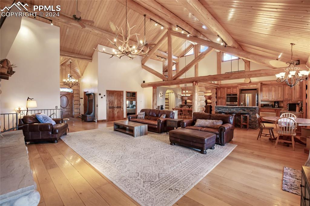 616 Summit Road Hartsel, CO 80449 - Photo 13 of 50 a living room with lots of furniture and a chandelier