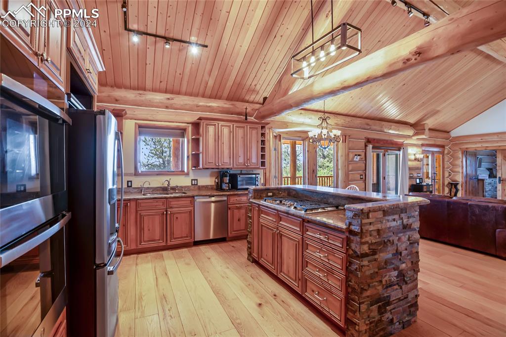 616 Summit Road Hartsel, CO 80449 - Photo 22 of 50 a kitchen with stainless steel appliances granite countertop a large stove a sink dishwasher and cabinets with wooden floor