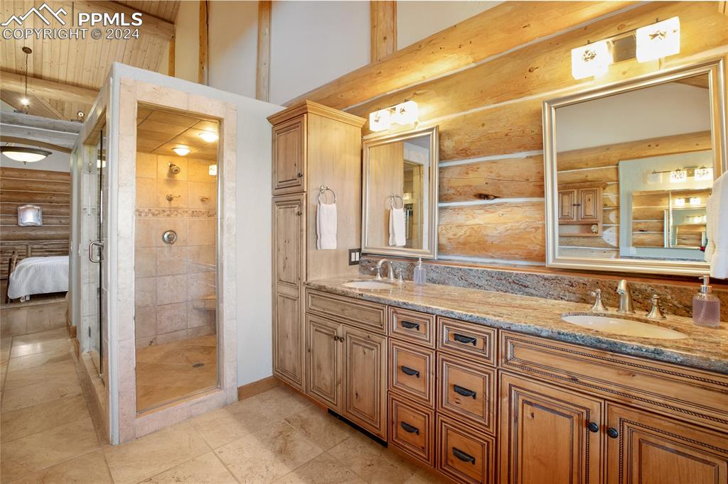 616 Summit Road Hartsel, CO 80449 - Photo 30 of 50 a bathroom with a shower sink and mirror