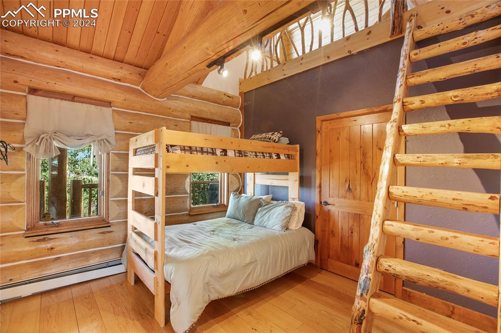 616 Summit Road Hartsel, CO 80449 - Photo 31 of 50 a bedroom with a bed and wooden floor