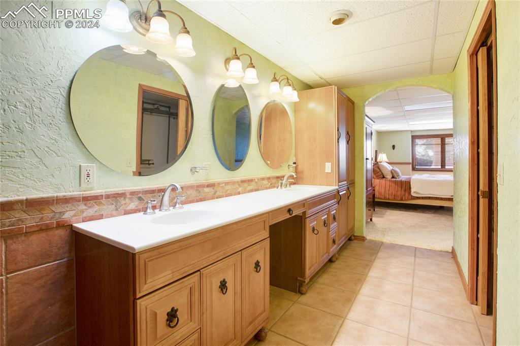 616 Summit Road Hartsel, CO 80449 - Photo 40 of 50 a spacious bathroom with a double vanity sink and a mirror
