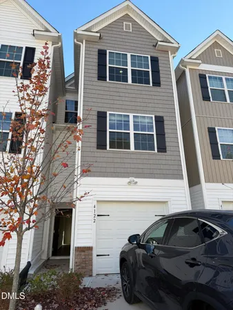 a front view of a house with parking space