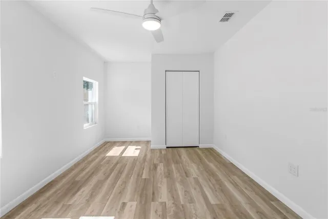 wooden floor in an empty room with a window