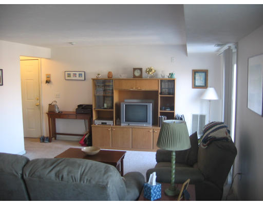 360 Littleton Road, Unit A11 Chelmsford, MA 01824 - Photo 4 of 8 a bedroom with furniture and a fireplace