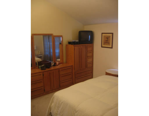 360 Littleton Road, Unit A11 Chelmsford, MA 01824 - Photo 6 of 8 a bedroom with a bed and wooden floor