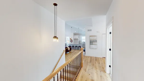 a view of a kitchen with furniture and wooden floor