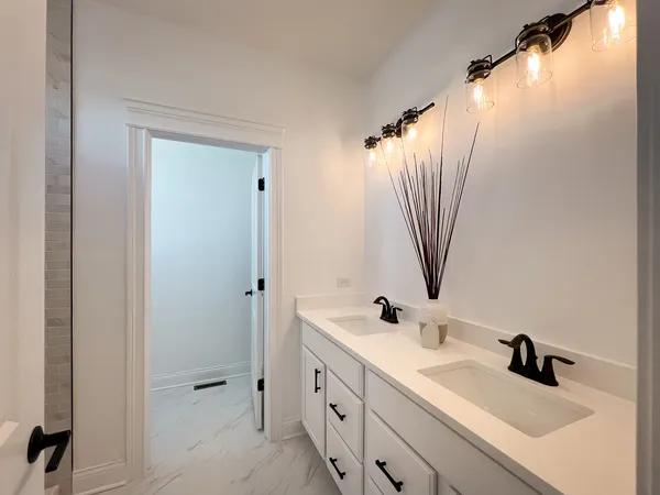a bathroom with a double vanity sink and mirror with shower