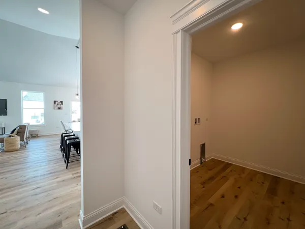 a view of a livingroom with wooden floor and furniture
