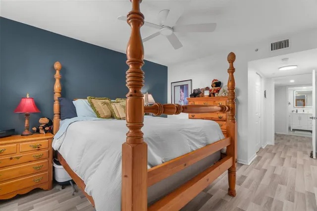 a bedroom with bed and wooden floor