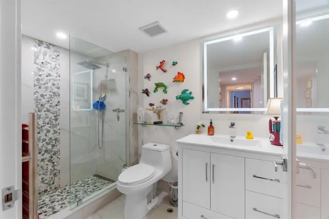 a bathroom with a toilet sink and shower curtain