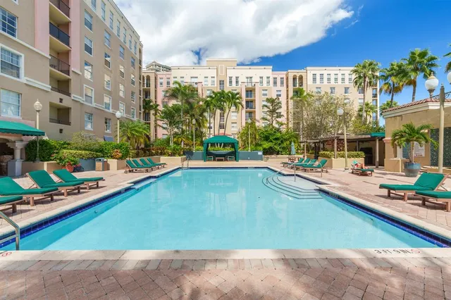 a view of a swimming pool with outdoor seating