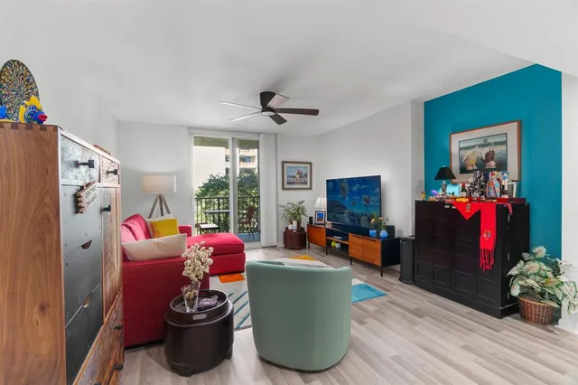 a living room with furniture fireplace and a window