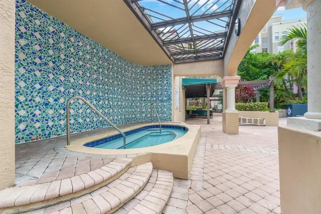 a view of a patio with furniture and a backyard