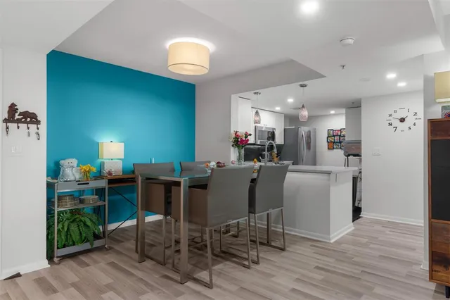 a view of a dining room with furniture and wooden floor