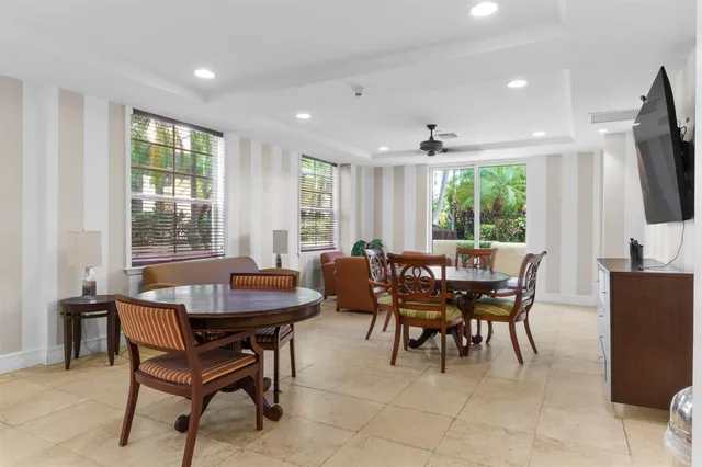 a view of a patio with a table and chairs and potted plants