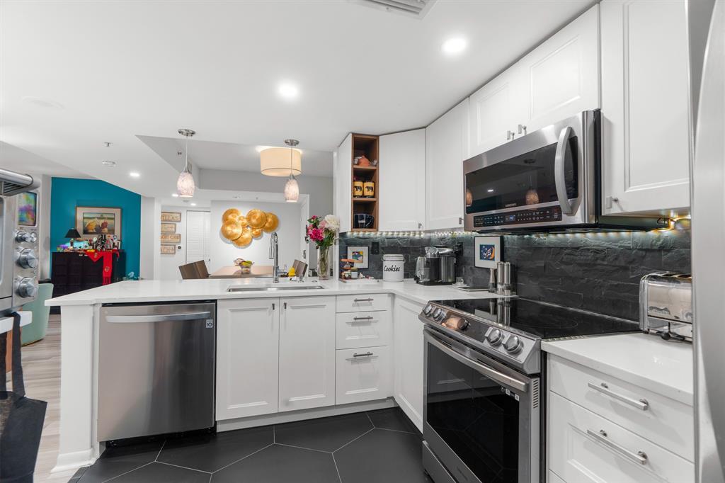 520 Southeast 5th Avenue, Unit 2209 Fort Lauderdale, FL 33301 - Photo 6 of 47 a kitchen with a sink stove and microwave