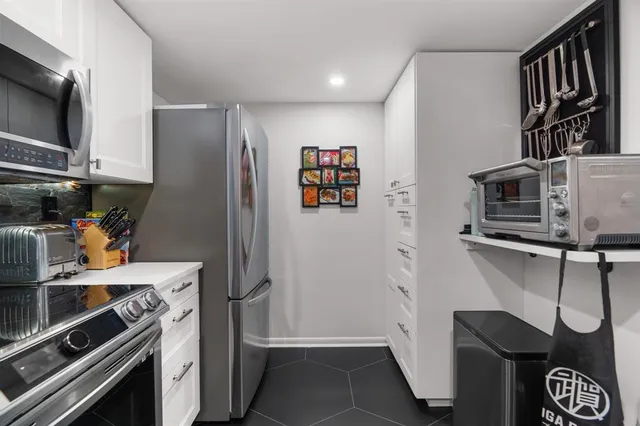 a kitchen with stainless steel appliances a refrigerator and a stove top oven
