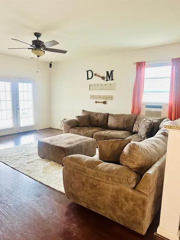 a living room with furniture and a wooden floor
