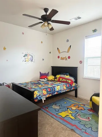 a bed room with furniture and painting on the wall