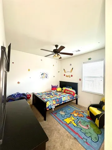 a bedroom with furniture and a window