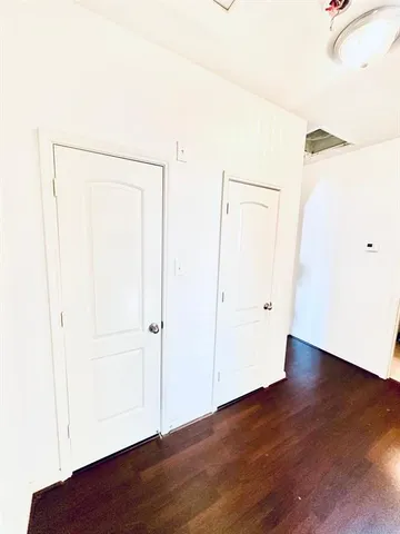 an empty room with wooden floor