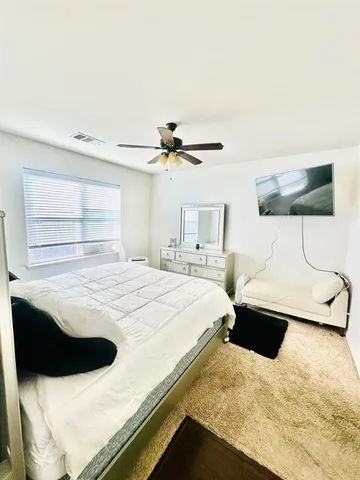 a bedroom with a bed and a night stand