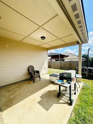 a backyard of a house with table and chairs