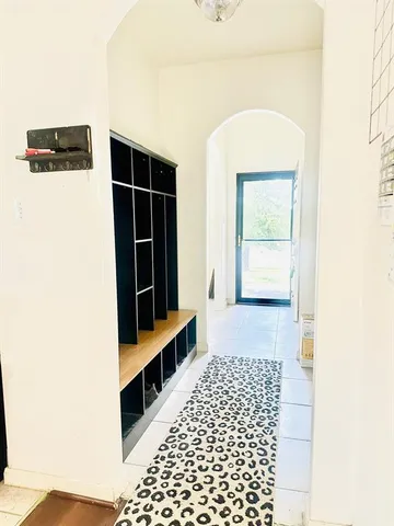 a view of hallway with a window and furniture