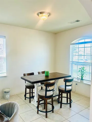 a view of a dining room with furniture and window