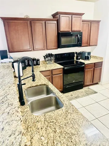 a kitchen with stainless steel appliances a sink and a counter space
