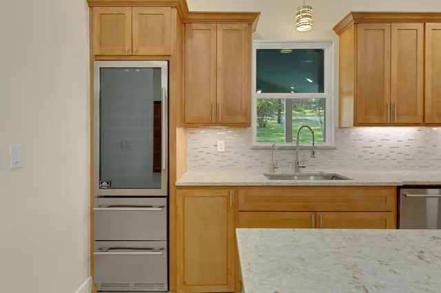 a large kitchen with a table and chairs