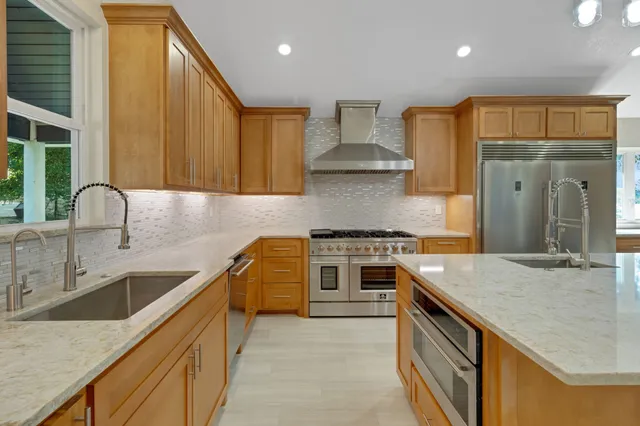a kitchen with a sink cabinets and wooden floor