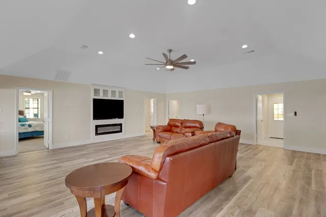 a view of a chairs and table in patio with wooden floor