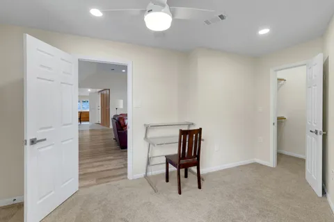 a bedroom with furniture and wooden floor