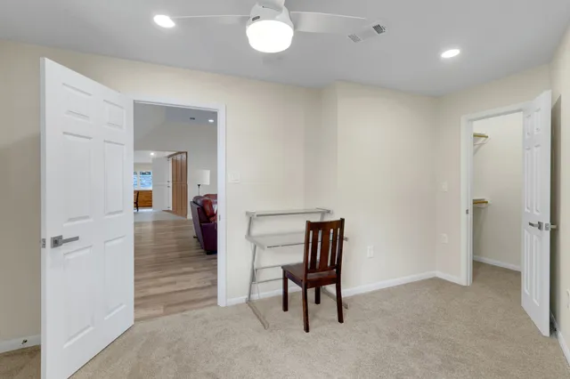 a bedroom with furniture and wooden floor