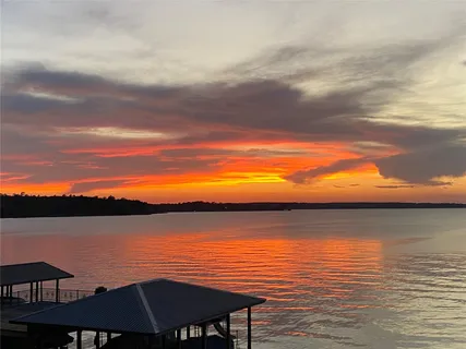 an aerial view of a house with a yard basket ball court and outdoor seating