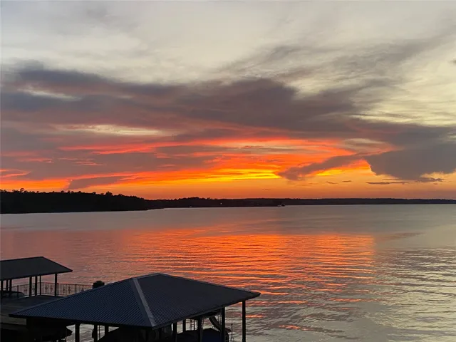 an aerial view of a house with a yard basket ball court and outdoor seating