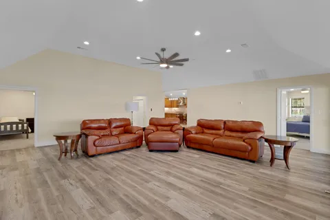 a kitchen with granite countertop a table chairs stainless steel appliances and cabinets
