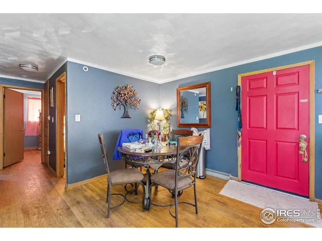 a view of a dining room with furniture and chandelier