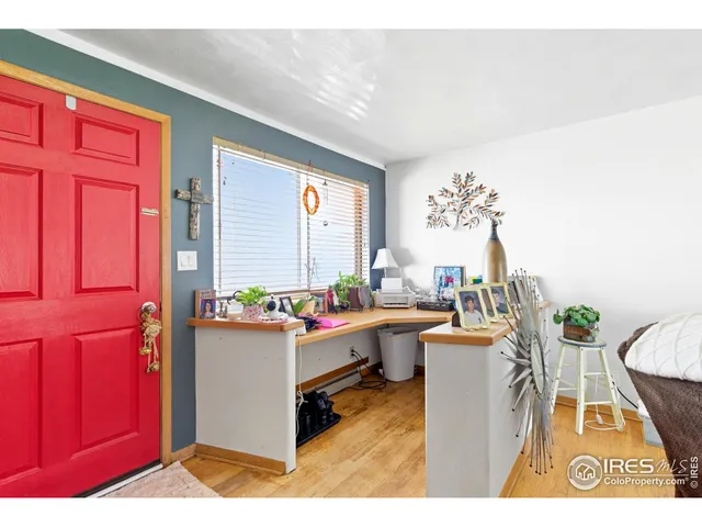 a bedroom with a bed a dresser next to a window