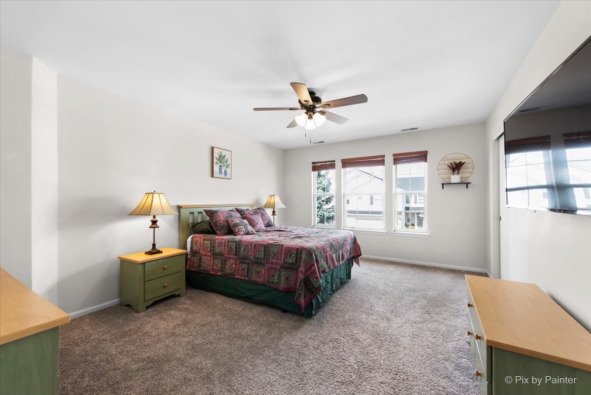 1033 Key Largo Drive Romeoville, IL 60446 - Photo 14 of 30 a spacious bedroom with a bed and windows