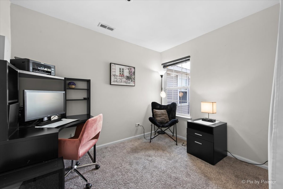 1033 Key Largo Drive Romeoville, IL 60446 - Photo 19 of 30 a view of a workspace with furniture and a window